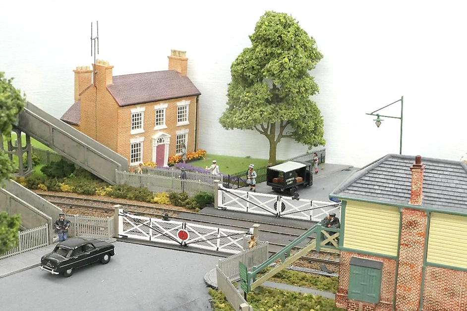 A toy train station with cars and buildings

AI-generated content may be incorrect.
