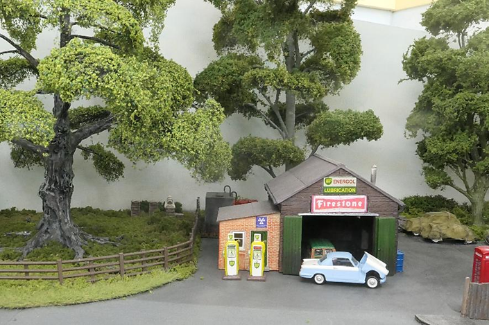 Just beyond the canopy of an oak tree (alongside the village garage) is a bee keeper attending to his hives.
www.EwhurstGreen.com

