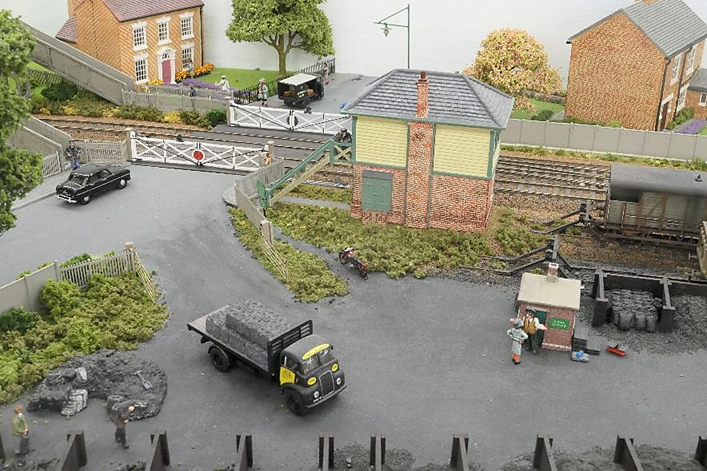 With his motorcycle parked below, the signalman looks down in amusement as a customer berates the railway’s coal merchant. Across the yard a local coal merchant wonders “Why didn’t she just come to me for her coal?”.
www.EwhurstGreen.com
