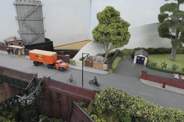 A model of a city with a truck and a bike

Description automatically generated