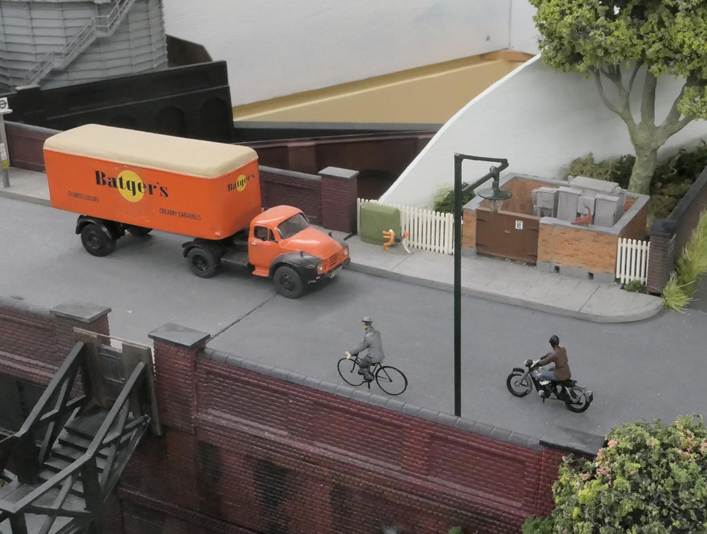 A model of a truck and a person riding a bicycle

Description automatically generated