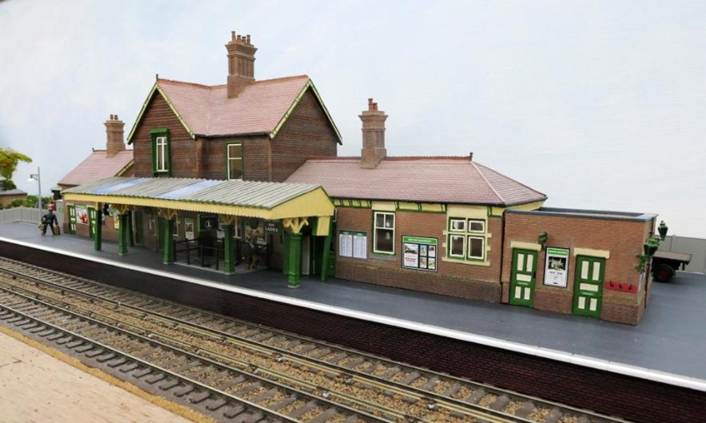 A train station with a building
AI-generated content may be incorrect.