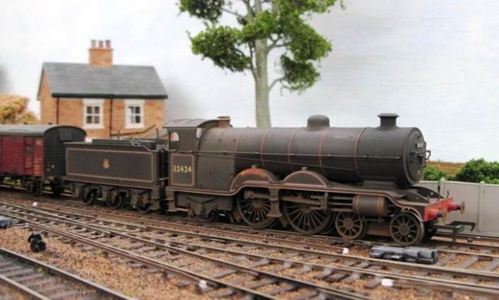 A model train on tracks
Description automatically generated